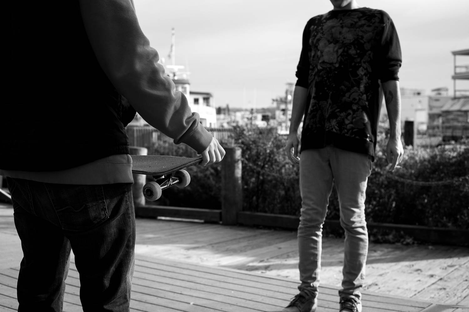 A skateboarder holding his skateboard