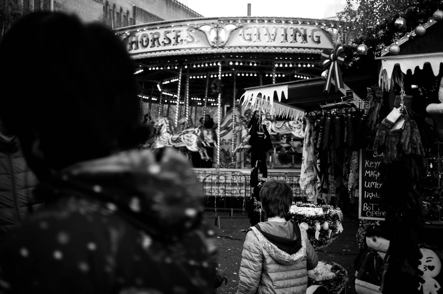 A child walks toward a spinning carousel in London
