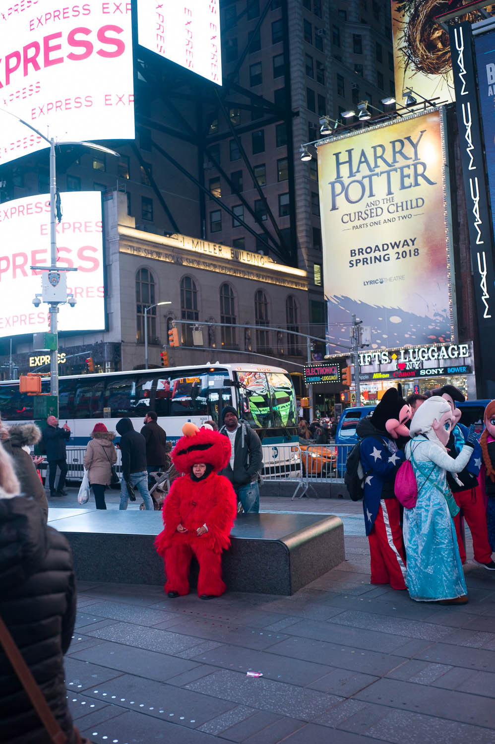 A person in an elmo suit catches a breather