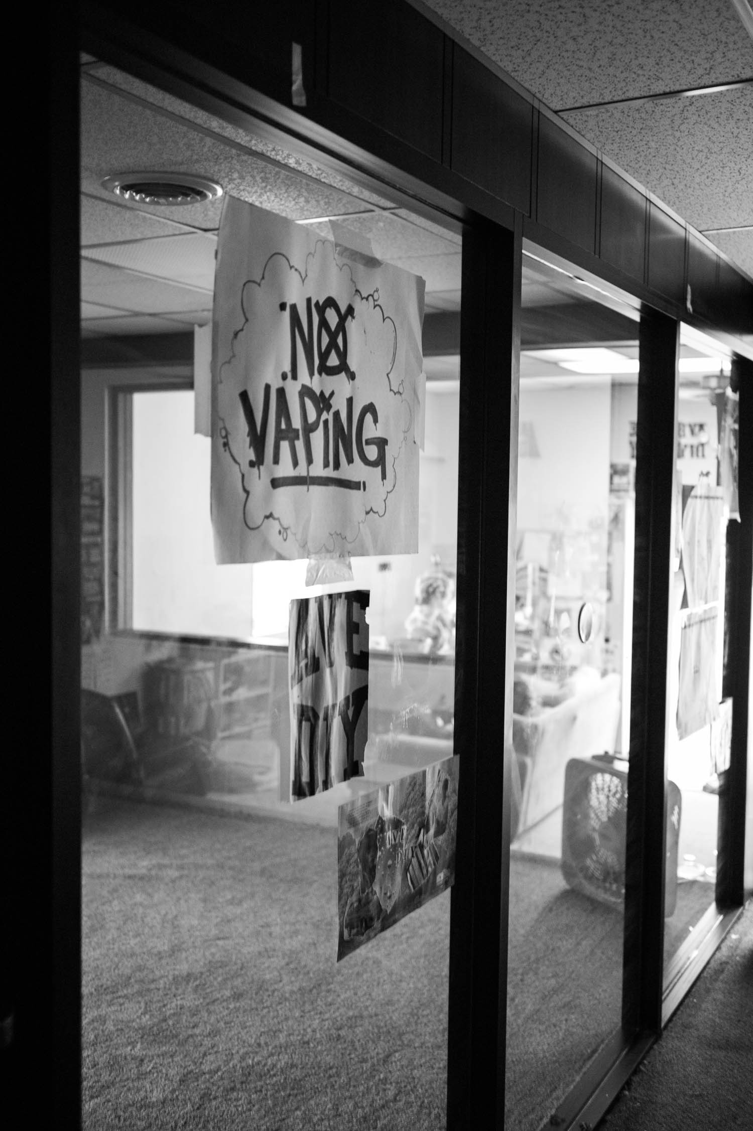 A "No Vaping' sign taped to a window at Ave DIY