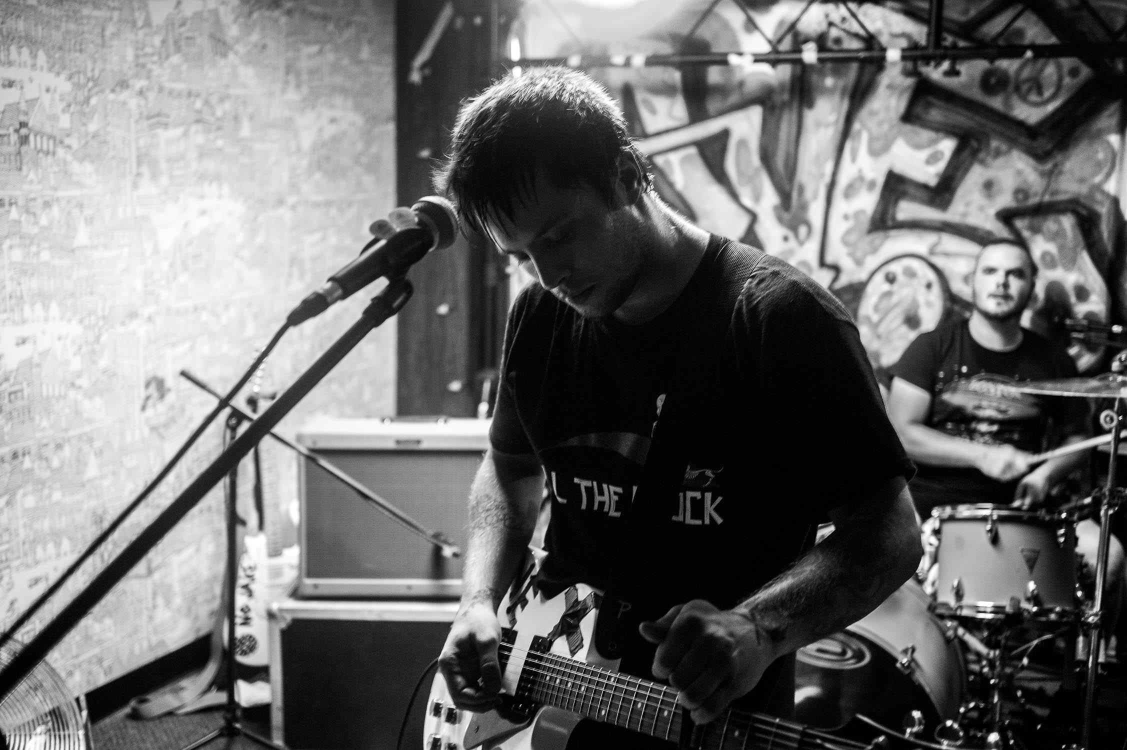 Tyler Reed of Second Suitor adjusts his capo during the Second Suitor Safe Space EP release show at Avenue D.I.Y. 