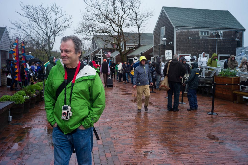 Thomas Risberg in Nantucket in May 2017 for NEWLK with a green rain jacket and waterproof camera.